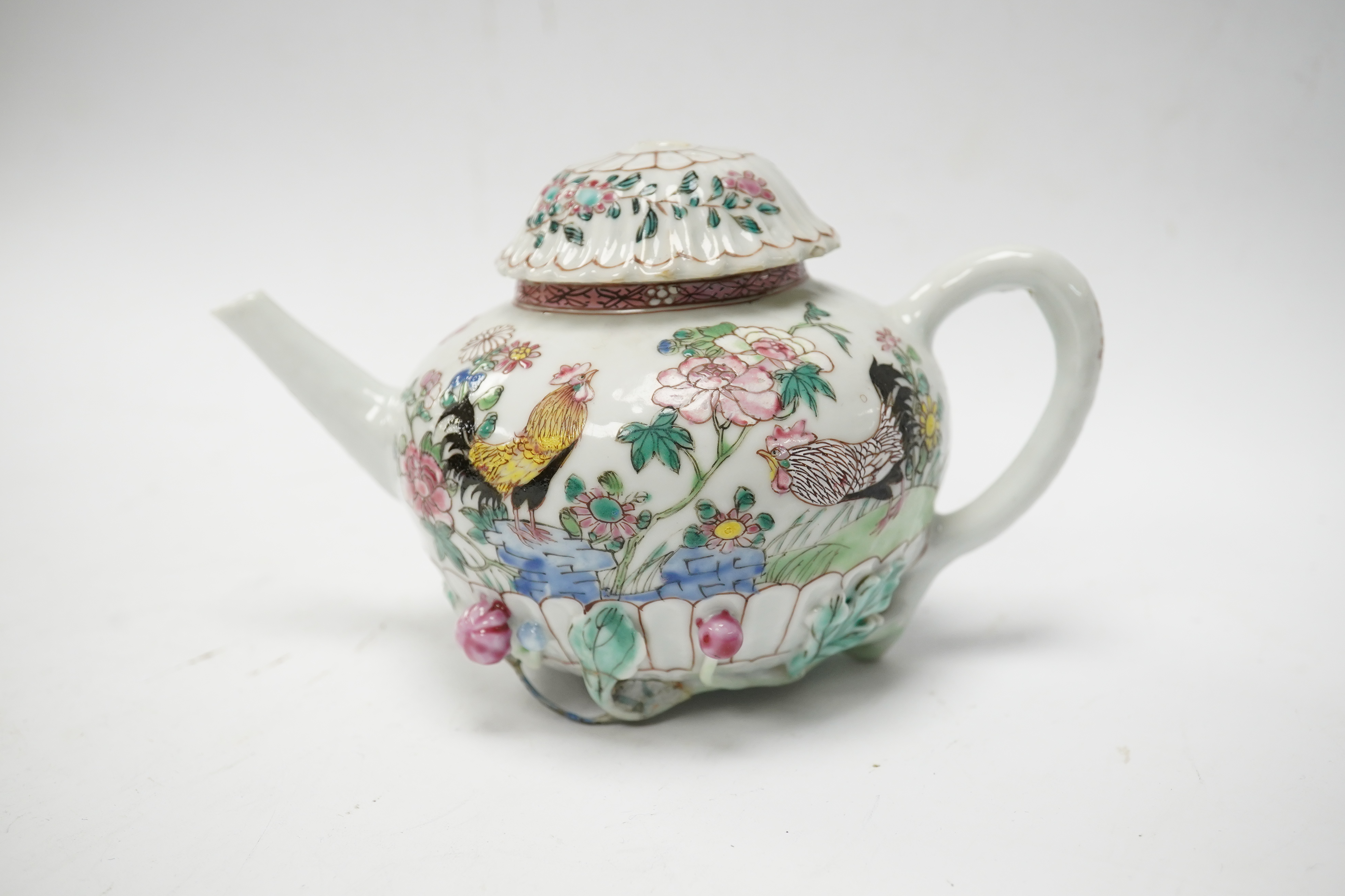 A Chinese famille rose chrysanthemum moulded teapot, early Qianlong period, painted with a cockerel amongst flowers, on a cage work base, 10cm high. Condition - restored